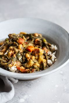 a white bowl filled with rice and vegetables