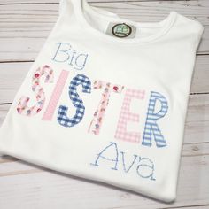 Big sister shirt Help big sister feel an important part of the day, which she is! Adorable applique shirt to proudly announce she is now a big sister! Available in short or long sleeve. Ships within 5-7 business days Thanks for shopping with Sew Blessed Stitches! Please visit our sister store at www.runningrosecreations.etsy.com We would love to connect with you on social media. You can find us at: Instagram - @sewblessedstitches Facebook - facebook.com/sewblessedstitches Email - sewblessedstitc Embroidered Cotton Top For Birthday, Personalized Cotton T-shirt For Gender Reveal, Personalized Cute Cotton Shirt, Cute Personalized Cotton Shirt, Cute Cotton Shirt For Gender Reveal, Cute Customizable Cotton Shirt, Cute Cotton Shirt With Name Print, Personalized Short Sleeve Cotton Shirt, Sister Matching Shirts