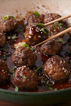 meatballs with sauce and chopsticks in a pan