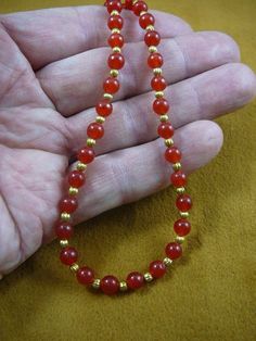 (Internal #V-321-8)  You are bidding on a beautiful, handmade, necklace made with round orange red carnelian 6 mm and gold plated spacer beads . Necklace is 16" long, with gold safety closure.* Want something larger, special order is $2.50 per inch.WE SHIP WORLDWIDE! Other accepted payment: Credit card (Mastercard/Visa/Discover) inquire for details. Red Carnelian Round Bead Jewelry, Gold Carnelian Beaded Necklaces For Healing, Gold Carnelian Beaded Necklace For Healing, Carnelian 8mm Beads Jewelry, Gold Carnelian Jewelry For Meditation, Red Carnelian Beaded Necklace Hand-strung, Red Carnelian Hand-strung Beaded Necklaces, Hand-strung Red Carnelian Beaded Necklaces, Carnelian Round Beads Necklace As Gift