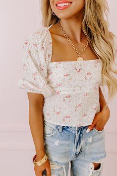 You will look so appealing in this flirty white crop top featuring lightweight material patterned with a small pink and green floral print, a square neckline, short puff sleeves, a wide open back with a lace up closure, and a flattering bodice that ends in a straight cropped front hemline! Measurements S : Bust 15", Hip 14", Length 17", Sleeve Length 15", Waist 14". M : Bust 16", Hip 15", Length 17.5", Sleeve Length 15.5", Waist 15". L : Bust 17", Hip 16", Length 18", Sleeve Length 16", Waist 16 White Floral Print Cropped Crop Top, White Floral Print Crop Top, Summer Floral Print Crop Top With Puff Sleeves, White Feminine Floral Print Crop Top, Summer Floral Print Crop Top With Square Neck, White Floral Print Feminine Crop Top, Summer Floral Print Puff Sleeve Crop Top, White Square Neck Crop Top For Day Out, Chic Floral Print Crop Top With Short Sleeves