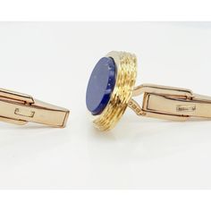 A fine pair of English Modernist cufflinks.  By Kutchinsky, the renowned London jewelry house.  In 18k gold and set with flat oval lapis cabochons.  Marked for 1970, a period in which Joseph Kutchinsky was at the height of his design influence.  These Modernist cufflinks have a wonderful tapered edge with hand tooling that obviously borrows design elements from Andrew Grima's work.  Fully hallmarked.  Simply wonderful high-level English Mid-Century Modern cufflinks!  Date: Mid-20th Century, 1970 Formal Lapis Lazuli Jewelry, Oval Gold Jewelry For Business, Oval Yellow Gold Jewelry For Business, Classic Yellow Gold Oval Cufflinks, Classic Oval Yellow Gold Cufflinks, Luxury Oval Cufflinks For Formal Occasions, Oval Polished Cufflinks For Business, Oval Yellow Gold Cufflinks For Gift, Timeless 14k Gold Polished Cufflinks