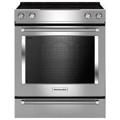 a stainless steel oven with the door open and its lights on, in front of a white background