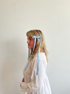 A playful spin on the classic hair bow, this micro bow with extra long tails makes a statement. Crafted out of 100% silk for a delicate drape and affixed to an alligator clip to easily wear in your hair or on the strap of a bag. Naturally dyed and hand crafted in our studio with love. Blue Hair Accessories For Summer Gift, Blue Adjustable Bow Hair Accessories, Adjustable Blue Bow Hair Accessories, Adjustable Blue Satin Bow, Adjustable Blue Ribbon Bow, Adjustable Blue Bow With Ribbon, Blue Ribbon Bow, Natural Indigo Dye, Classic Hair