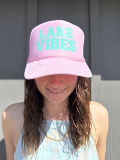 Lake Vibes Pink Trucker hat with blue font. Adjustable back strap and french terry head band. Summer Sports Hat With Flat Brim, Spring Sports Trucker Hat, Casual Visor Hat With Sweatband, Spring Sports Trucker Hat One Size, Spring Trucker Hat With Letter Print And Flat Brim, Spring Sports Trucker Hat, One Size Fits Most, Casual Pink Snapback Hat For Vacation, Trendy Summer Sports Snapback Hat, Casual Hat With Sweatband, One Size Fits Most