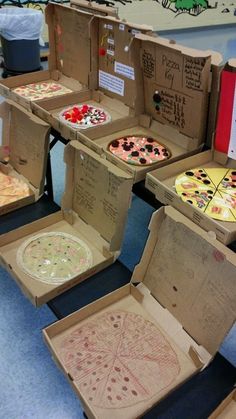 several pizzas are sitting in boxes on the floor