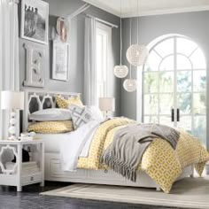 a bedroom with gray walls and white furniture