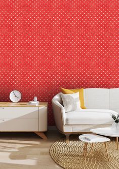 a living room with red and white polka dot wallpaper on the walls, couches and coffee table