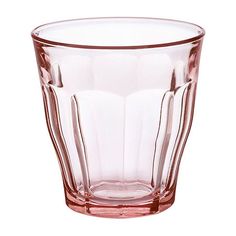 a clear glass cup sitting on top of a white table