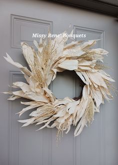 a dried wreath on the front door of a house