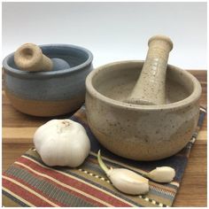 two bowls and one garlic on a table