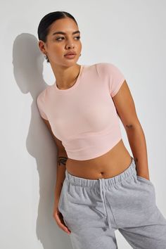 A softer-than-soft fitted baby tee in a cropped length. Features - Short sleeves - Classic crew neck Size & Fit - Fitted, stretch ribbed knit - Cropped length (hits above the belly button) Materials & Care - 57% cotton, 38% viscose, 5% spandex - Machine wash, cold - Imported Spring Color Season, Pink Top Outfit, Baby Pink Crop Top, Peach Top, Pink Activewear, Outfit Hacks, Color Season, Pink Spring, Spring Color