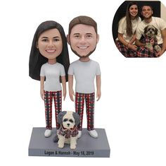 a custom bobble head couple and their dog are posed for a photo with the family's pet