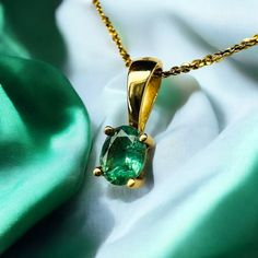 SAME DAY SHIPPING! This is a gorgeous solid 18k Yellow Gold necklace with a mesmerizing oval cut natural EARTH MINED Colombian Emerald gemstone in an oval cut. The solid 18k yellow gold chain is approximately 16 inches long, pendant approximately 11.5mmx4.2mm. Weighs 2.1g. Excellent anniversary gift for wife, girlfriend, may birthstone birthday gift for daughter, etc.!  Mothers Day Gift or Christmas Gift! Fun fact: Cleopatra is known to have used emeralds often in her royal adornments We also se Classic Yellow Gold Emerald Necklace With Oval Pendant, Classic Oval Emerald Necklace For May Birthstone, Classic Yellow Gold Oval Emerald Necklace, Classic Oval Emerald Birthstone Necklace, Oval Yellow Gold Jewelry With Birthstone, Classic Oval Emerald Necklace In Yellow Gold, Classic Gold Emerald Oval Pendant Necklace, Classic Gold Emerald Necklace With Oval Pendant, Classic Emerald Oval Pendant Necklace