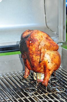 a whole chicken is on the grill with it's legs still in the oven