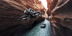 two small boats floating in the middle of a narrow river surrounded by rocks and cliffs