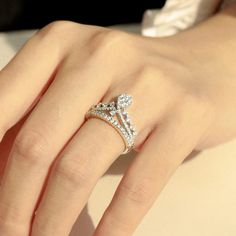 a woman's hand with a diamond ring on it