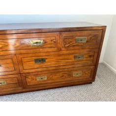 a large wooden dresser sitting on top of a carpeted floor