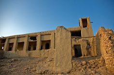 an old adobe building in the middle of nowhere