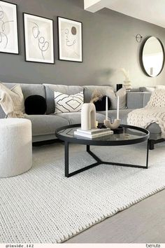 a living room filled with lots of furniture and pictures on the wall above it's coffee table