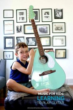 a young boy sitting on top of a ottoman holding an acoustic guitar with the words music for kids learning to play guitar