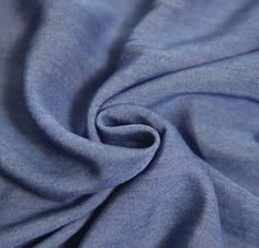 a close up view of the fabric on a blue shirting material that is very soft