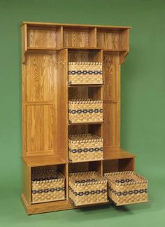 a wooden cabinet with baskets in it