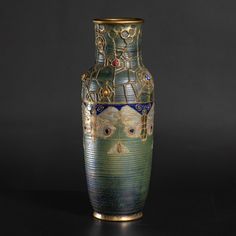 a large vase sitting on top of a table next to a black wall and floor