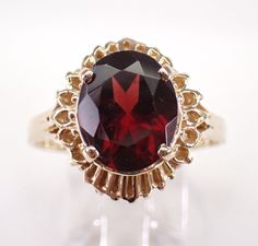 Vintage 14K Yellow Gold Garnet Engagement Ring. This ring is set with one Oval Garnet in the center. This Garnet measures 11 X 9 mm and weighs 4 carats. This ring is solid 14KT Yellow Gold, weighs 5.9 grams and is a finger size 9 1/2, which can be resized (please inquire about sizing with the finger size you need). The top of this ring measures 15.5 X 14 mm. I will ship this ring promptly in a beautiful gift box. January Birthstone Jewelry, Garnet Engagement Ring, Yellow Gold Solitaire, Solitaire Setting, January Birthstone, Beautiful Gift Boxes, Birthstone Jewelry, Solitaire Ring, Ring Verlobung