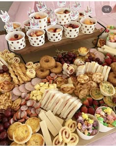 a table filled with lots of different types of food and desserts on top of it