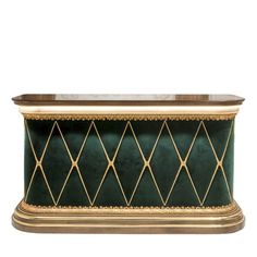 a green and gold planter with an intricate design on the top, in front of a white background