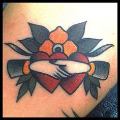 a close up of a tattoo on a person's leg with an orange flower