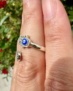 🌟 Welcome to Shine Bright Crystals! 🌟 📏 Size: Adjustable Adorn yourself with the protective energy and stylish design of this adjustable stainless steel Hamsa and Evil Eye ring. Perfect for fashion, protection, and meaningful gift giving, this unique piece of jewelry offers both symbolism and versatility. 🧿 Hamsa and Evil Eye Design: Symbols of protection and warding off negativity 🌟 Stainless Steel Setting: High-quality, durable, and hypoallergenic ✨ Adjustable Size: Ensures a perfect fit for any finger 🧘 Benefits: Promotes protection, good luck, and spiritual well-being 🎁 Gift Idea: Ideal for jewelry lovers and those seeking meaningful symbols Elevate your style and safeguard your energy with the timeless elegance and protective power of this Hamsa and Evil Eye stainless steel adj Adjustable Metal Jewelry For Promise, Adjustable Sterling Silver Evil Eye Jewelry, Adjustable Nickel-free Promise Ring, Nickel-free Adjustable Promise Rings, Adjustable Silver Spiritual Midi Rings, Adjustable Nickel-free Stainless Steel Rings, Adjustable Stainless Steel Nickel-free Rings, Adjustable Hypoallergenic Stainless Steel Jewelry, Hypoallergenic Adjustable Stainless Steel Jewelry