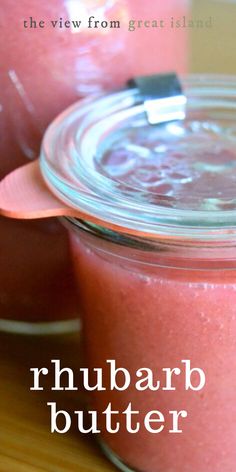 a jar filled with pink colored liquid sitting on top of a wooden table