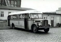 an old black and white photo of a bus