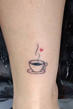 a small cup of coffee with a heart on the side of its leg is shown