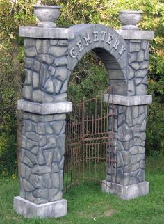 a stone gate with an arch that says cemetery