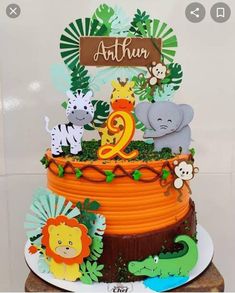 a birthday cake decorated with animals and plants