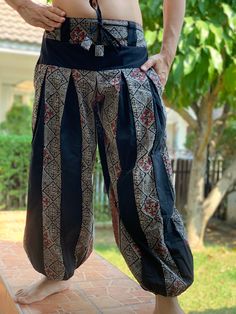 "These super soft rayon baggy unisex harem pants have the \"flow\", perfect of yoga or just a cool strolling. Comfort and character are what these pants are all about. They have the traditional sarong look & feel but a lot more practical when it comes to activity like yoga. As a bonus, they are convertible! Just pull them up and you get yourself a cute jumpsuit in a flash. Together with elastic cuff legs, you can wear them short or long. The pants have smock waist (wide bang elastic) with no Loose Fit Harem Pants For Yoga And Festivals, Harem Bottoms For Yoga And Festivals, Black Bohemian Harem Pants With Relaxed Fit, Black Bohemian Relaxed Fit Harem Pants, Black Cotton Harem Yoga Pants, Traditional Relaxed Fit Harem Pants For Yoga, Black Cotton Harem Pants For Yoga, Baggy Black Harem Pants For Festival, Traditional Wide Leg Harem Pants For Meditation