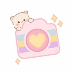 a teddy bear laying on top of a pink camera