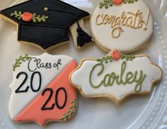 decorated cookies on a plate with graduation caps and tassels for class of 20