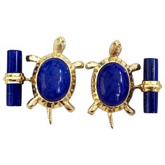 These unique cufflinks combine the deep blue of lapis lazuli with the warmth of 18 karat yellow gold. The precious metal is used to make the post and mounting of the front face in the shape of the legs and tail of a turtle, while the cylindrical toggle and the shell of the animal are in lapis lazuli. All AVGVSTA jewelry is new and has never been previously owned or worn. Each item will arrive beautifully gift wrapped in a AVGVSTA box, put inside an jewel box and with a elegant pouch with an expe Elegant Pouch, Watch Cufflinks, Cufflink Set, Unique Diamonds, Precious Metal, Yellow Sapphire, The Deep, Deep Blue, Lapis Lazuli