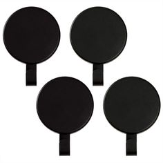 four black round plates on a white background