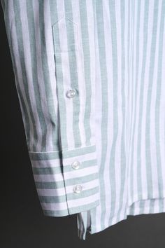 A bespoke shirt crafted from a textured cotton blend fabric in an oversized candy stripe. The larger striped pattern gives it a punch of style, making it a great casual shirt that can be worn with chinos or jeans - or under suits and jackets. The lightweight fabric drapes effortlessly, making it an ideal choice for those seeking a sophisticated yet relaxed look. Cotton Vertical Stripes Collared Shirt, Yarn-dyed Striped Collared Shirt, Pinstripe Cotton Top With Spread Collar, Pinstripe Cotton Shirt With Striped Collar, Cotton Button-up Tops With Horizontal Stripes, Striped Cotton Shirt With Placket, Striped Shirt With Button Cuffs For Daywear, Striped Cotton Top With Spread Collar, Cotton Tops With Vertical Stripes And Spread Collar