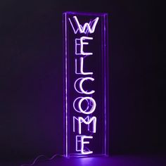 a neon sign that says welcome to someone