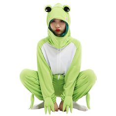 a person in a frog costume sitting on the ground