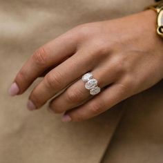 a close up of a person wearing a ring with flowers on it's finger