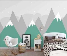 a bedroom with mountains painted on the wall and a bed in front of it,