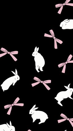 rabbits with pink bows on black background