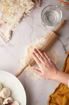 a person is kneading some food on a table